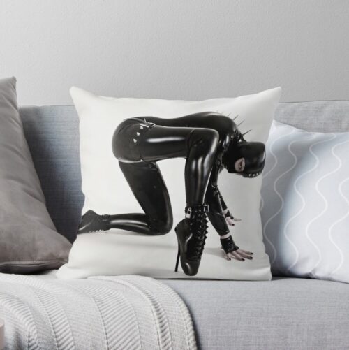 This creature wears a black latex catsuit. With steel spikes emerging from her back! The creature is completely covered in shiny rubber. We can only see one feral eye peering out.